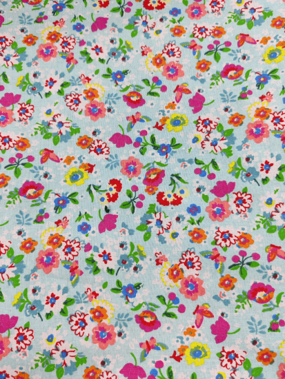 Tissu coton fleurs multicolores sur fond bleu ciel