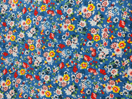 Tissu coton fleurs multicolores sur fond bleu