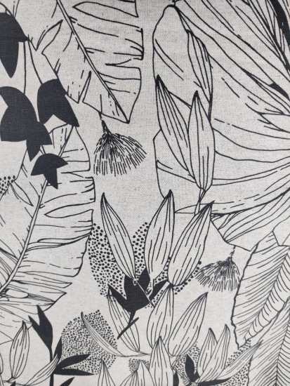 Tissu coton enduit grandes feuilles noires sur fond gris